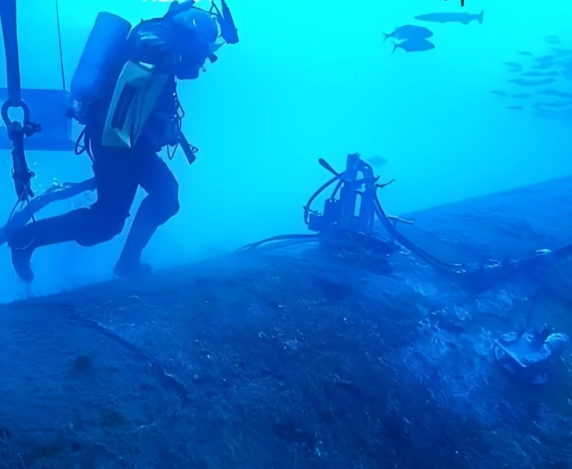 A diver stands on the wreck of the Munger T. Ball. This vessel was sunk on May 4, 1942 by a German U-Boat.